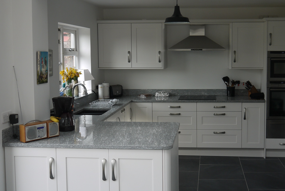 White Storm Granite (cabinetry by Cloisters Design)